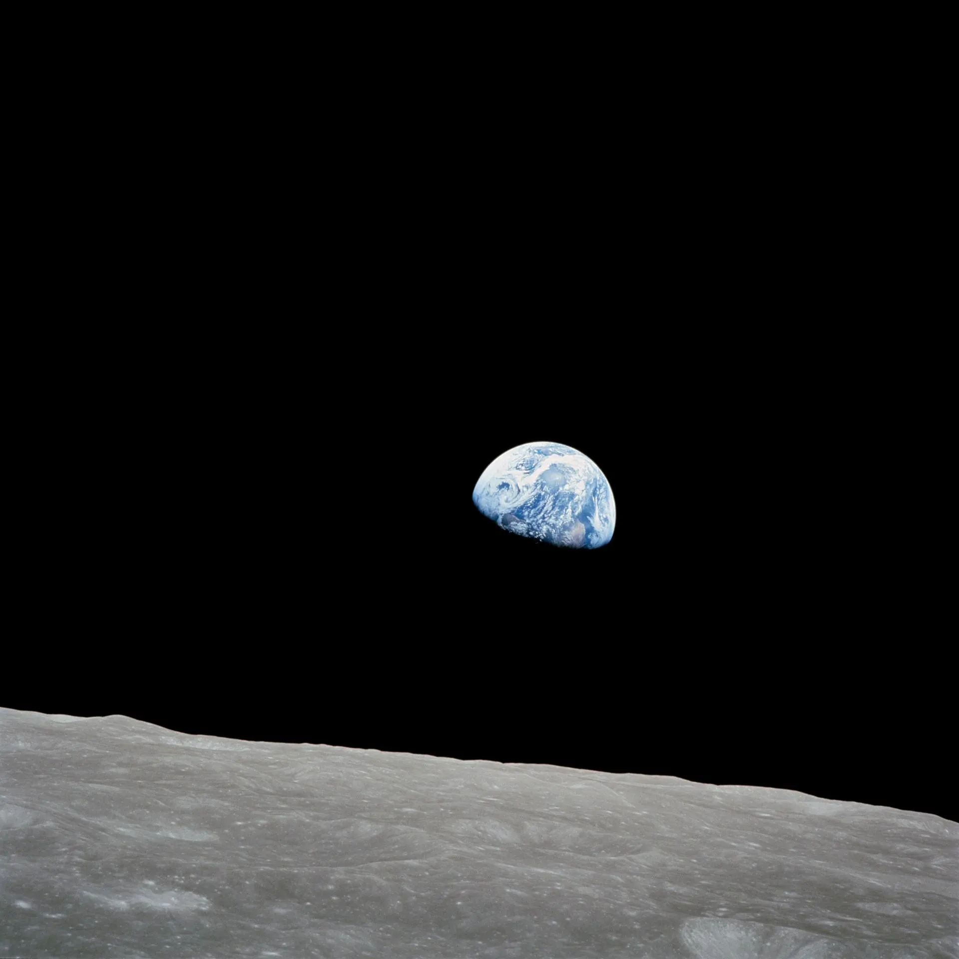 Earthrise: Earth rising over the lunar horizon, photographed by the crew of Apollo 8